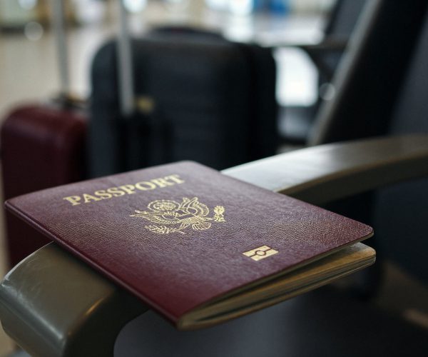 passport-chair-arm-with-luggage-background